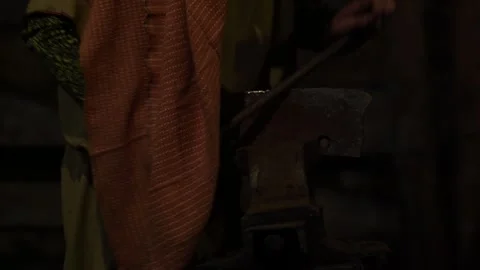 Master Craftsman Shapes Iron Tool with a File, Handcrafted in the Stock Footage 260374313
