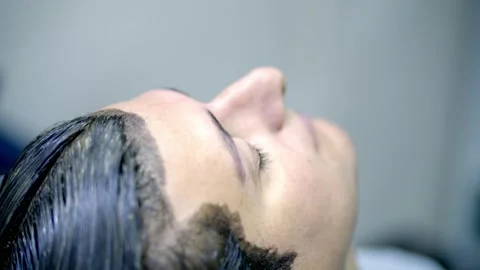 Master cuts the eyebrows of the client Stock Footage 142317013