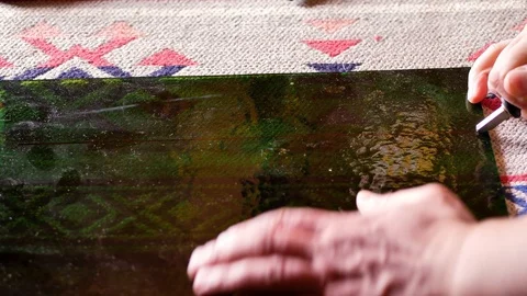 The master cuts the glass to make a lamp using the tiffany technique Stock Footage 124528770