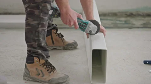 The master cuts off a plastic ventilation duct with an angle grinder Stock Footage 262950971