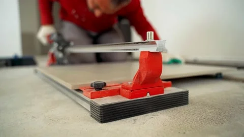 Master cuts the tile with a tile cutter Stock Footage 152097149