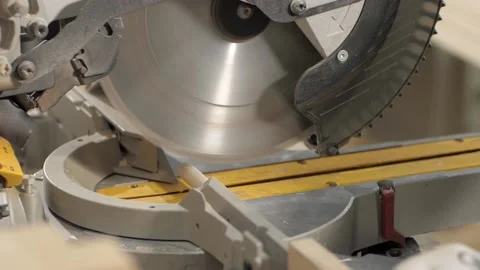 The master cuts a wooden peg with a circular saw in the woodworking workshop. Stock Footage 207079482