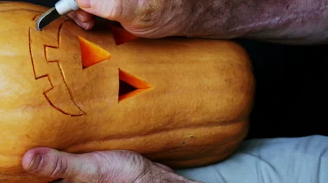 Master cutting jack-o-lantern out of pumpkin 1. Stock Footage 64974150