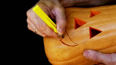 Master cutting jack-o-lantern out of pumpkin 3. Stock Footage 64974263