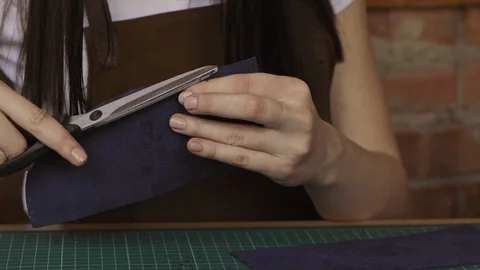 Master cutting leather with scissors. Process of manufacturing leather wallet Stock Footage 108912451