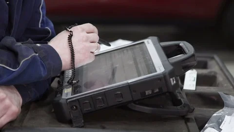 Master diagnostician checks data in diagnostic scanner Stock Footage 75320845