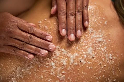 The master does a back massage with special oils and sea salt, spa treatments Stock Photos