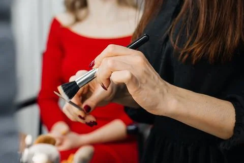 Master does a beautiful blonde makeup in a beauty salon Stock Photos