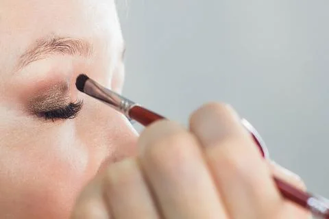 Master does a beautiful blonde makeup in a beauty salon Stock Photos