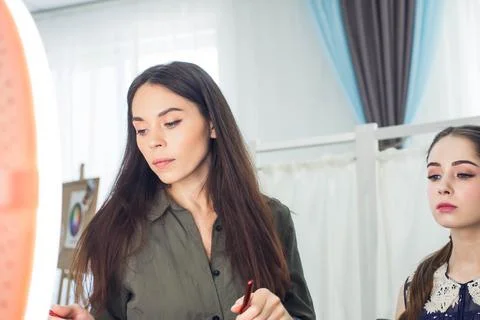 Master does a beautiful blonde makeup in a beauty salon Stock Photos