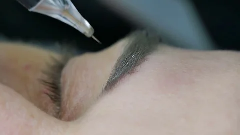 Master does tattoo of brows close-up Stock Footage 76679523