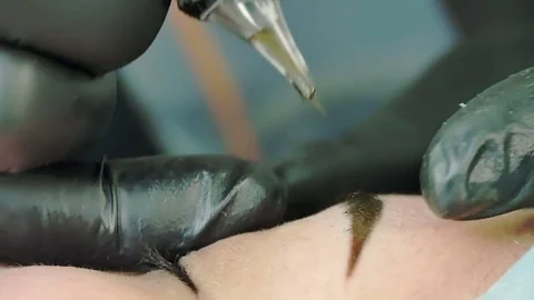 Master does tattoo of eyebrows close-up Stock Footage 76667539