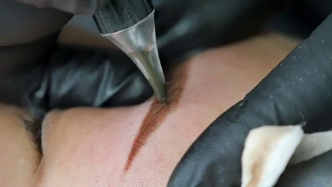 Master does tattoo of eyebrows close-up Stock Footage 76675077