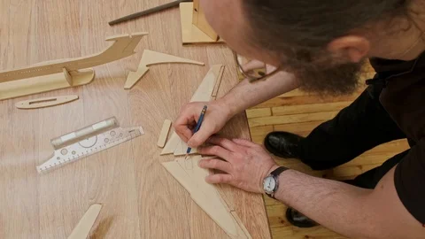 Master draws out and shows wooden jetliner wing detail Stock Footage 127377136