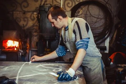 The master draws on the table Stock Photos