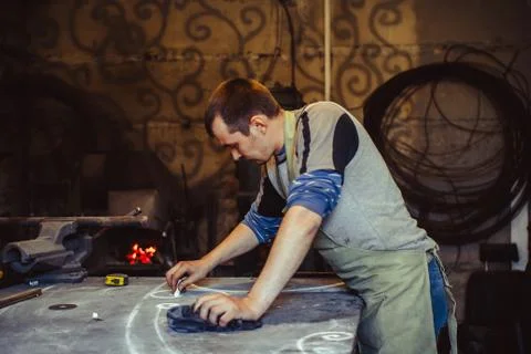 The master draws on the table Stock Photos