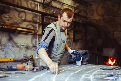 The master draws on the table Stock Photos