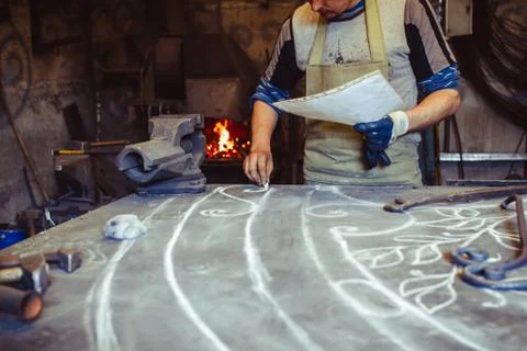 The master draws on the table Stock Photos