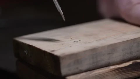 Master drills a hole in the Board Stock Footage 130698960