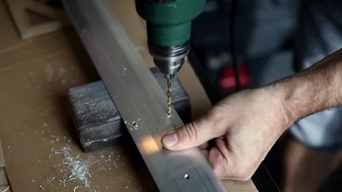 The master drills holes in the metal panel Stock Footage 196953419