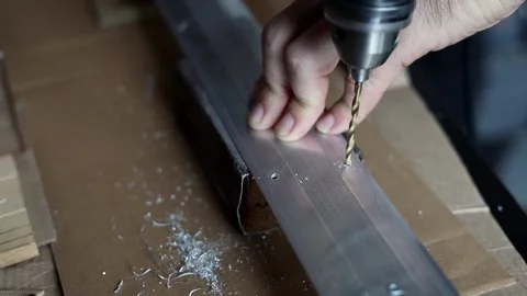 The master drills holes in the metal panel Stock Footage 196953424