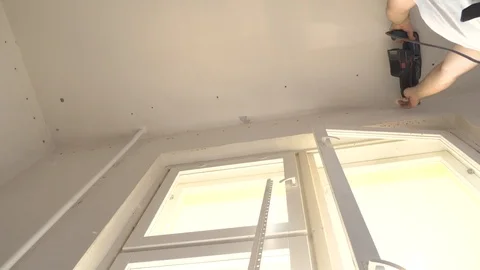 Master drills the wall with a perforator, for mounting a false ceiling. Stock Footage 127568246