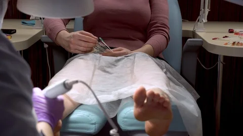 Master during a pedicure. The process of professional pedicures. Beauty salon Stock Footage 102779221