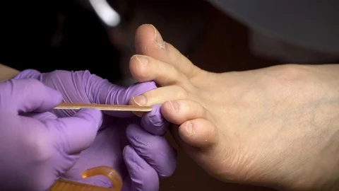 The master during a pedicure in salon. The process of professional pedicure. Stock Footage 102779480