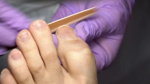 The master during a pedicure in salon. The process of professional pedicure. Stock Footage 102779648