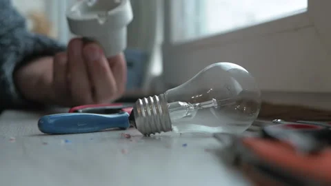 Master electrician connect the wires to the socket for the electric lamp Stock Footage 221875941