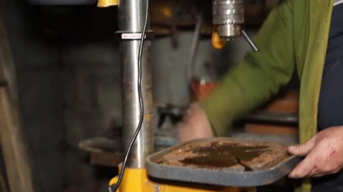 A master engineer is drilling steal on a drilling machine Stock Footage 237156113
