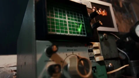 Master engineer electrician configures the oscilloscope device close up Stock Footage 84577266