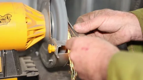 A master engineer is grinding the blade of the knife Stock Footage 237156146