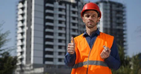 Master Engineer Man Posing a Serious Thumb Up Sign Engineering a Modern Building Stock Photos