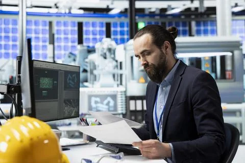 Master engineer reviewing data for the production line in a solar factory Stock Photos