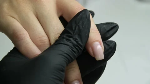 The master examines the client's nails Stock Footage 205524677