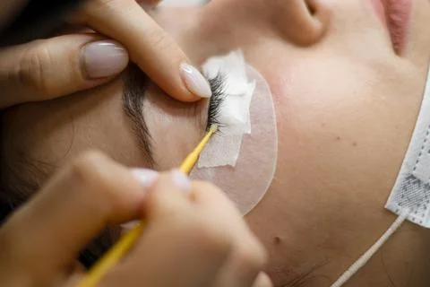 The master extends eyelashes. Stock Photos