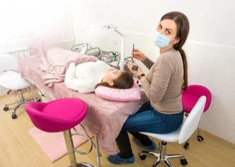 Master eyelash extension in the process Stock Photos