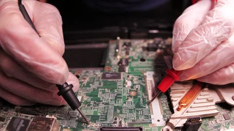 The master fixes notebook motherboard, using tools. Close up hands, black table Stock-Footage 261412452