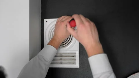 Master fixing ventilation at home. Close up shot hands twirl screw screwdriver Stock Footage 153280616