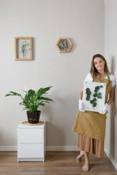 Master of the frame of flowers. Framing dried plants. Stock Photos