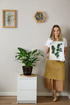 Master of the frame of flowers. Framing dried plants. Stock Photos