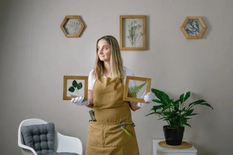 Master of the frame of flowers. Framing dried plants. Stock Photos