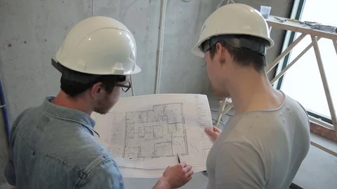 Master gives instructions according to the drawing on the paper. Stock Footage 79334335