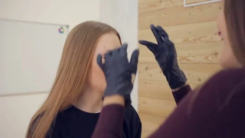 Master in gloves does tattoo of eyebrows close-up Video stock 81322909