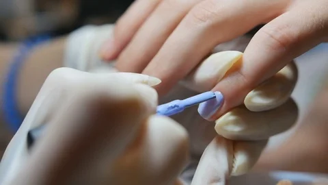 Master in gloves makes a manicure close-up Stock Footage 79712638