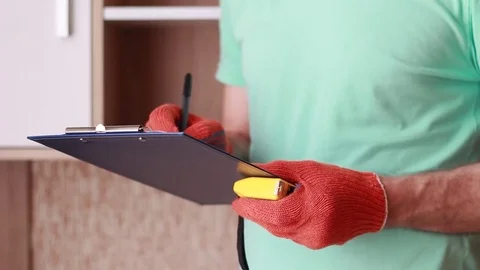 Master in gloves writing with tape-line in hands 動画素材 85167121