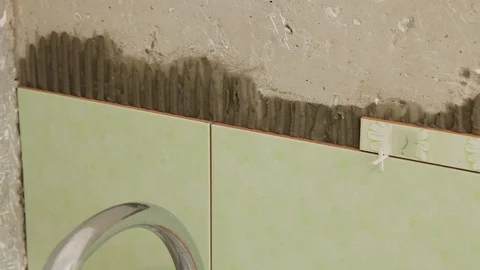 Master glues the tile on the wall. Stock Footage 101685460