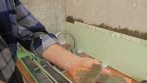 Master glues the tile on the wall. Stock Footage 101685466