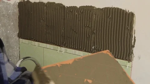 Master glues the tile on the wall. Stock Footage 101685480